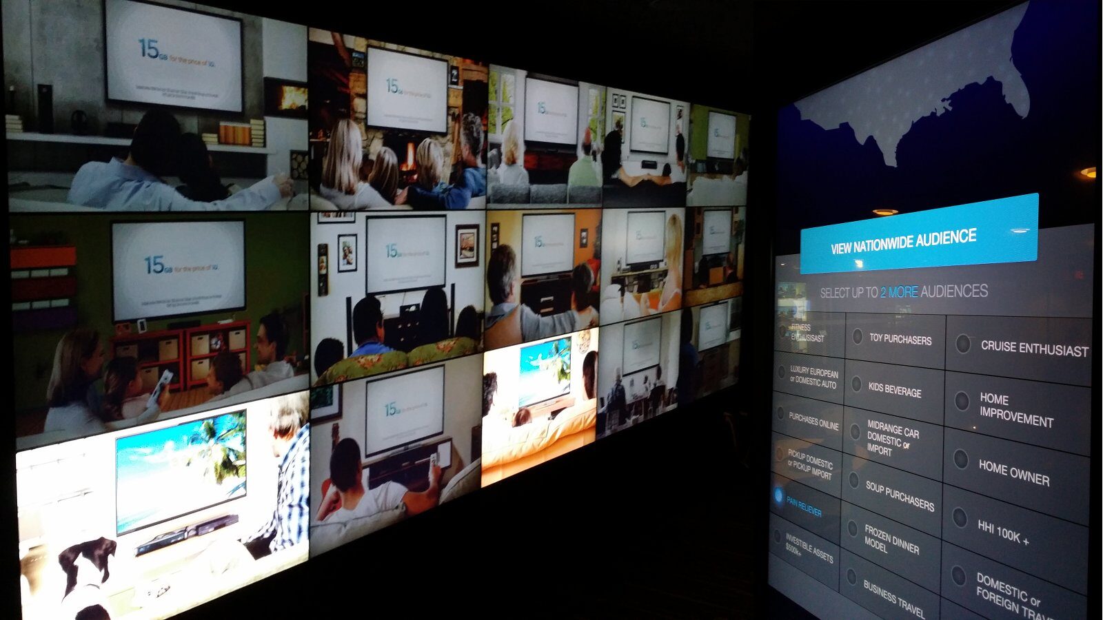 A curved video wall and touchscreen in a dark room