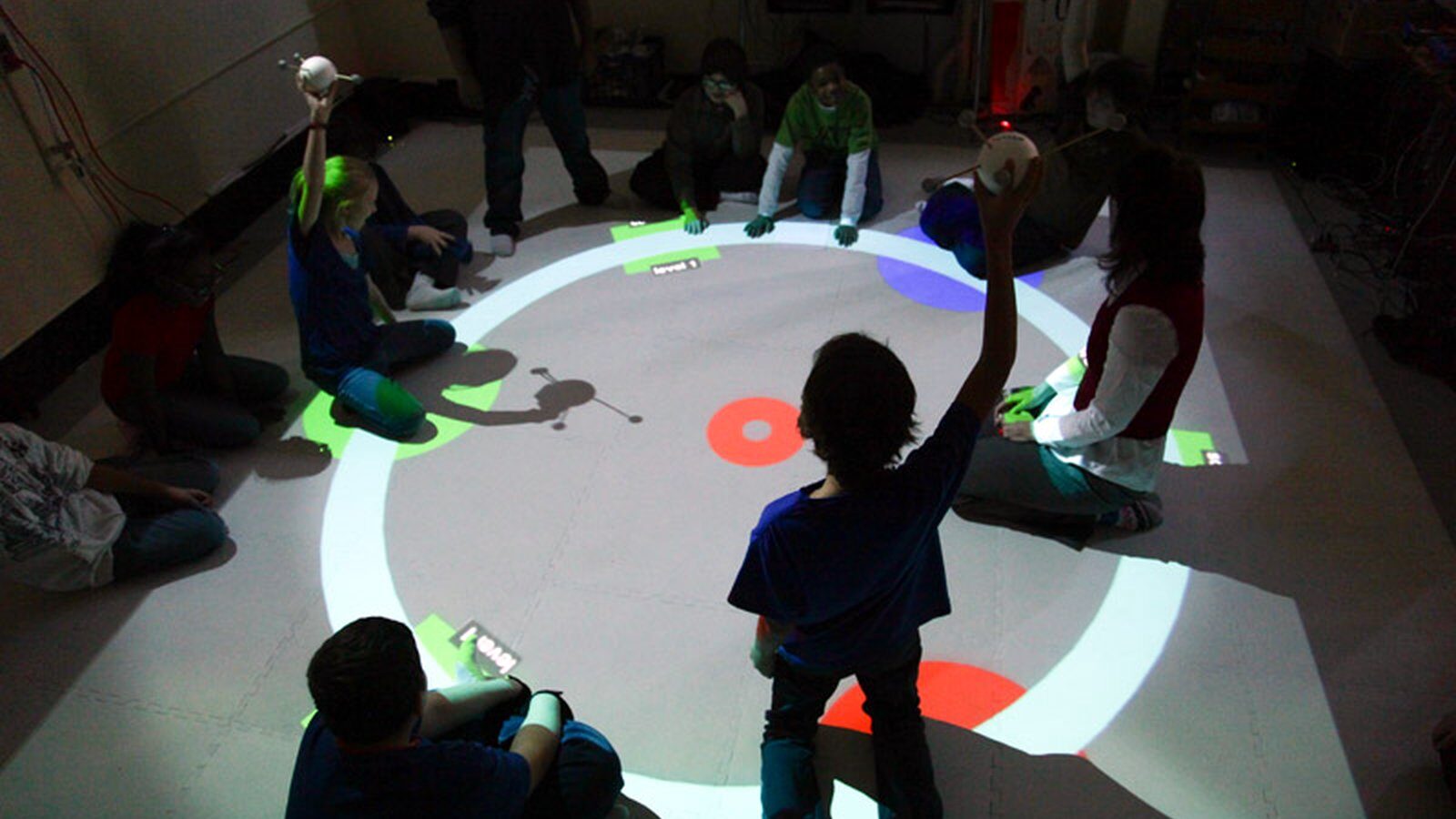 Students playing on a projected floor
